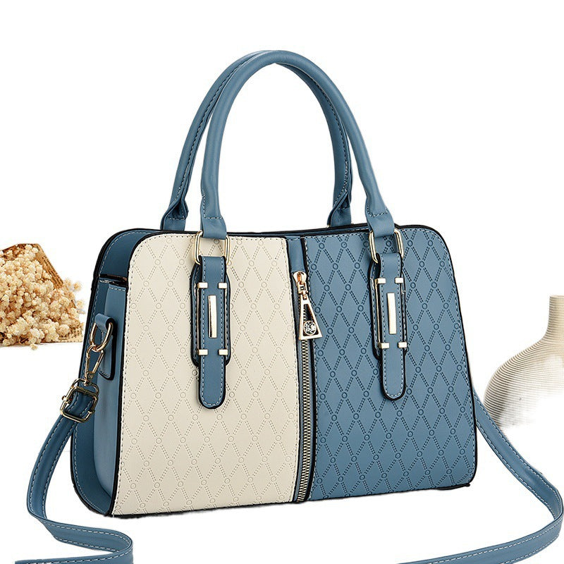 Blue and beige handbag with a strap on a white background