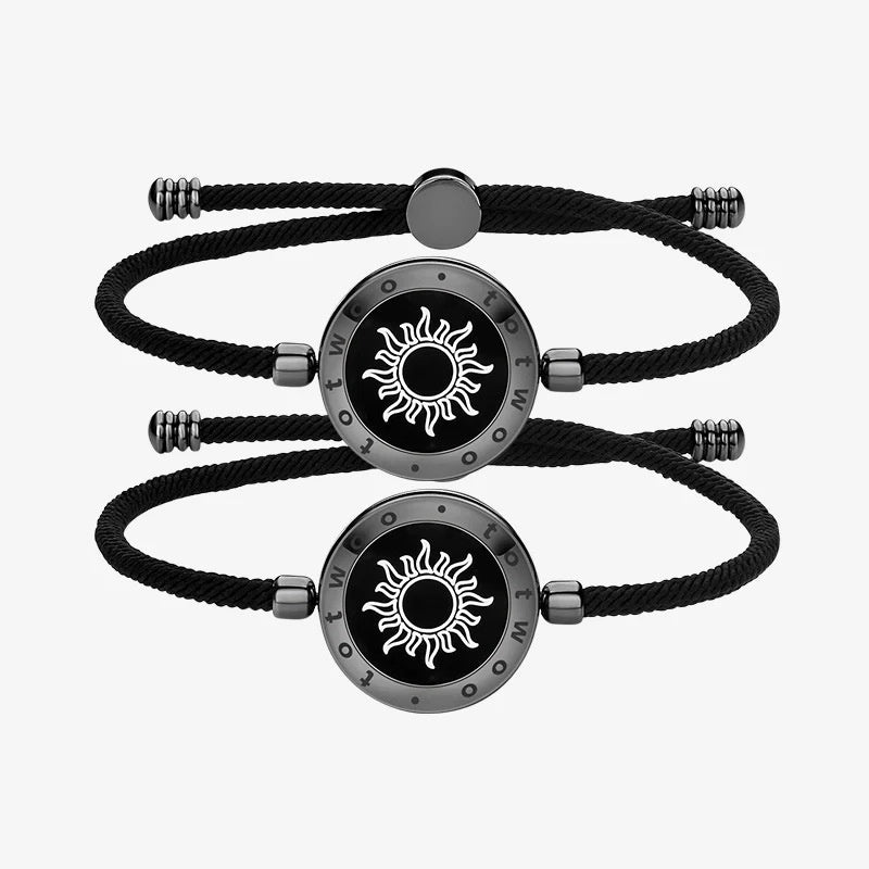 Black braided bracelets with silver circular charms featuring sun designs on a white background