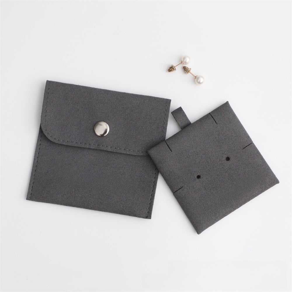 Two gray fabric pouches on a white background