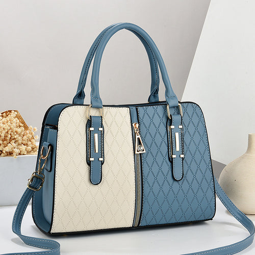 Blue and beige handbag with a strap on a light gray background