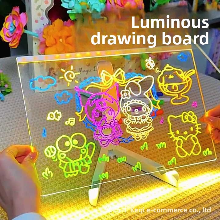 Luminous drawing board with colorful drawings on a table.