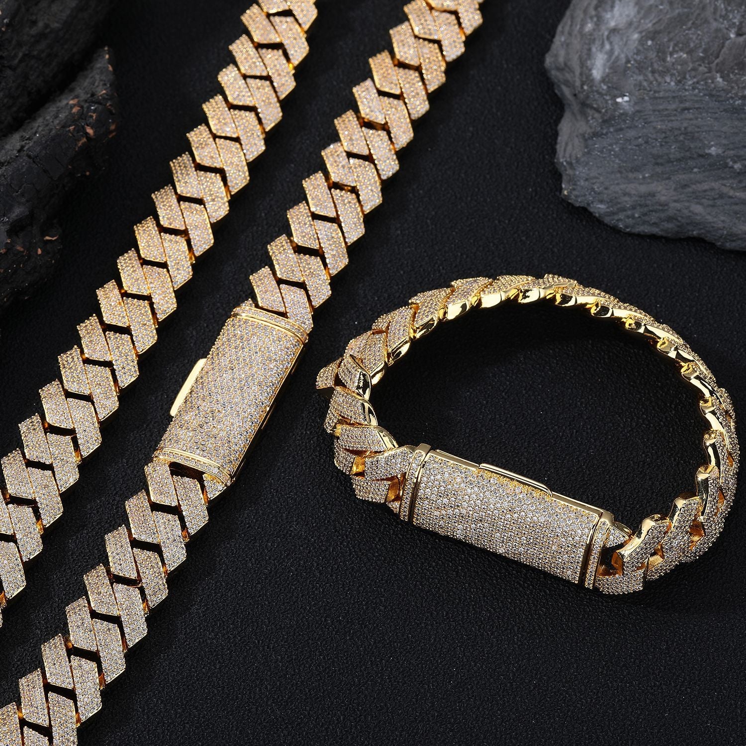 Gold chain bracelet on a dark surface with rocks