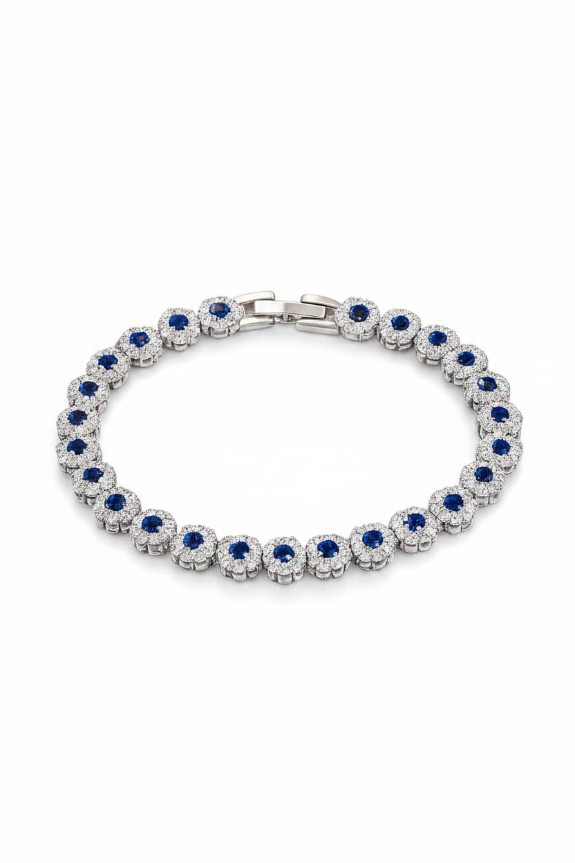 Silver bracelet with blue and clear stones on a white background, featuring the Luvora brand.