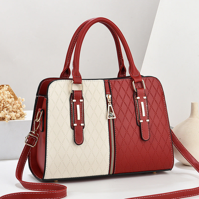 Red and white handbag with a strap on a light background