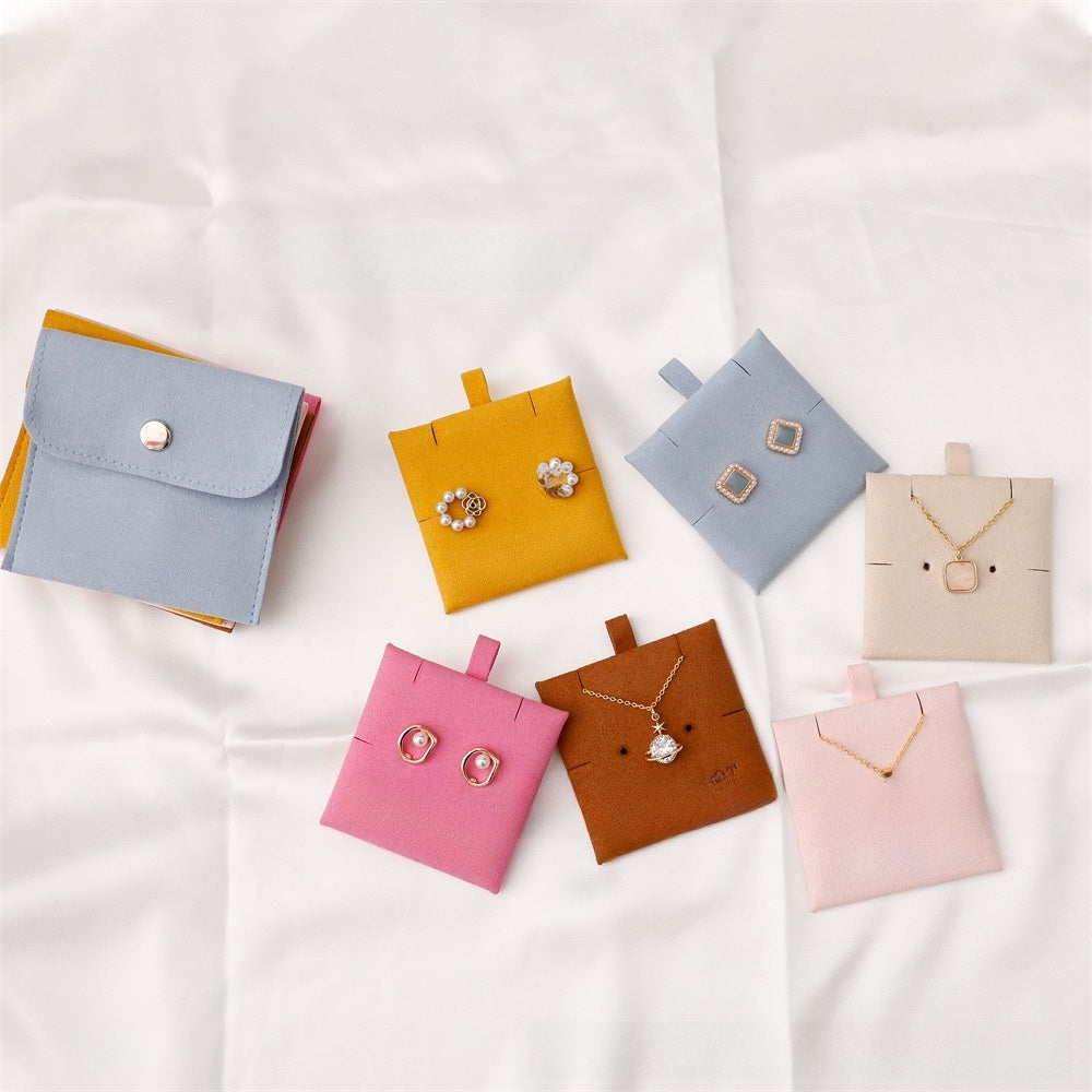 Jewelry boxes with earrings and necklaces on a white background