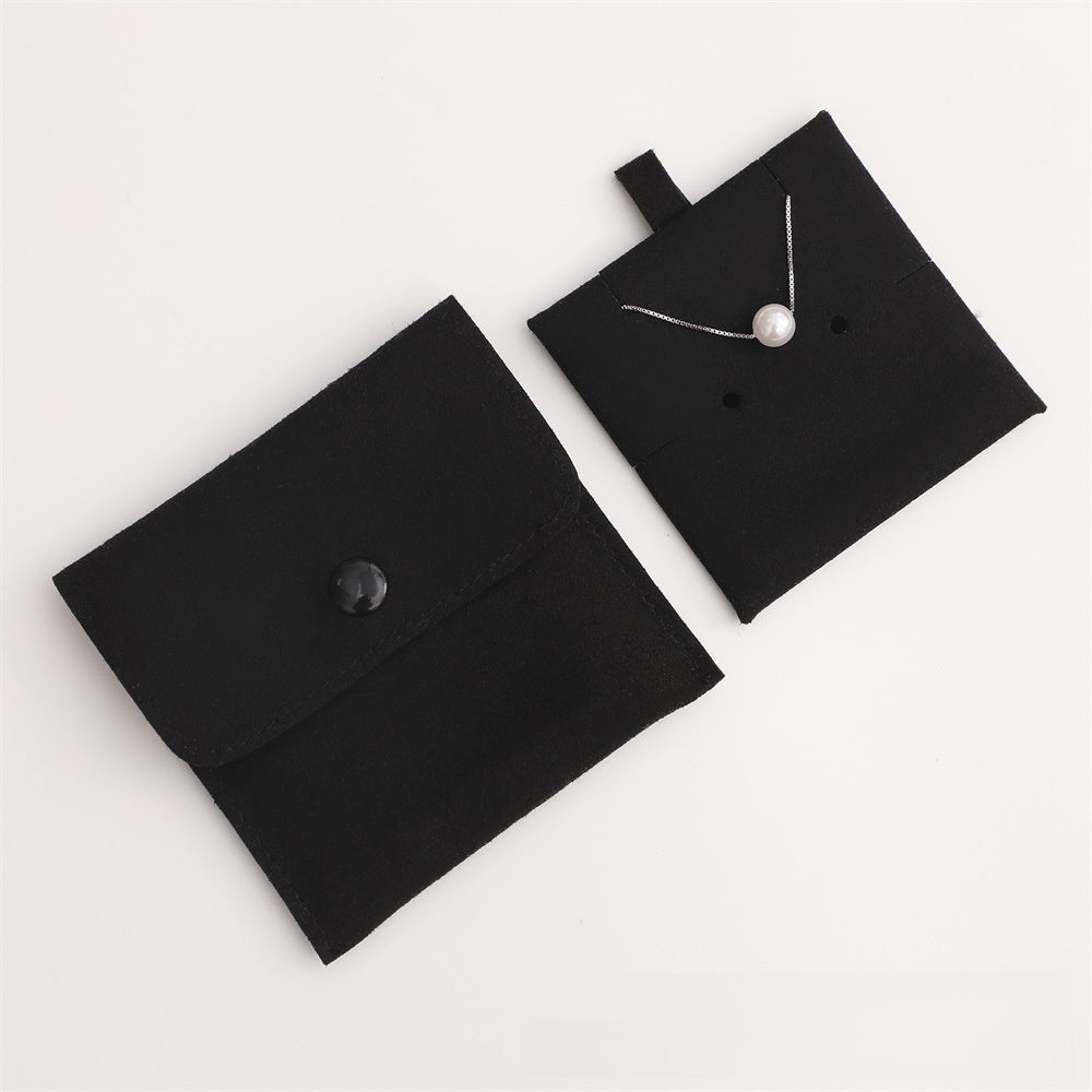 Black jewelry pouch with a necklace on a white background