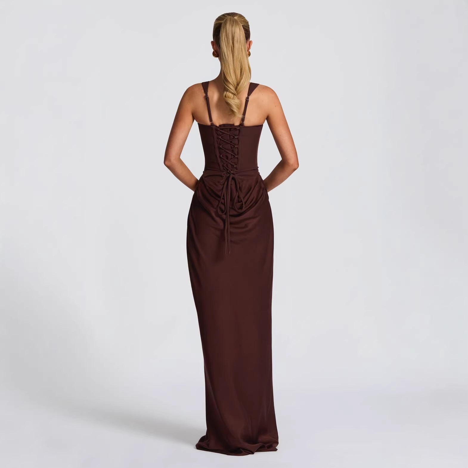 Woman wearing a brown evening gown on a white background