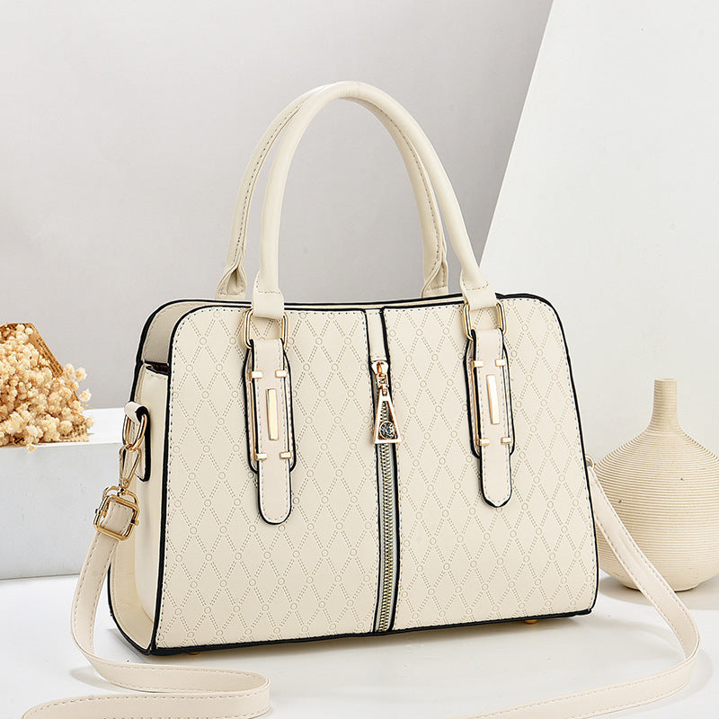 White handbag with black accents on a light gray background