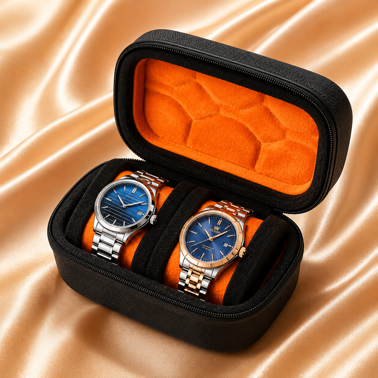 An open black zippered watch presentation case with bright orange interior lining, holding two wristwatches with blue dials and metal bracelets, set on a shiny champagne satin background.