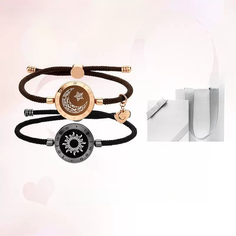 Black cord bracelets with sun and moon designs on a white background