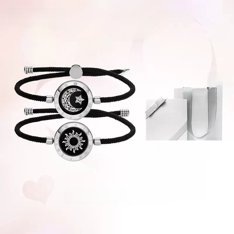 Black cord bracelets with sun and moon designs on a white background