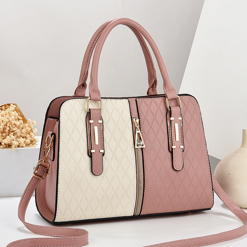 Pink and beige handbag with a strap on a light background