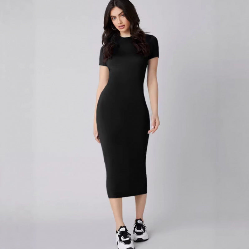 Woman wearing a black dress on a gray background