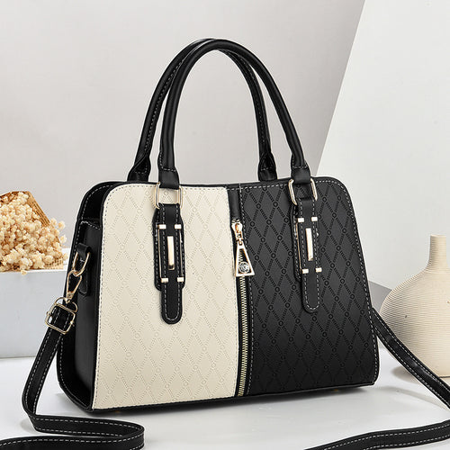 Black and white handbag with quilted design on a light gray background