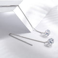 Silver earrings with clear gemstones on a light gray background