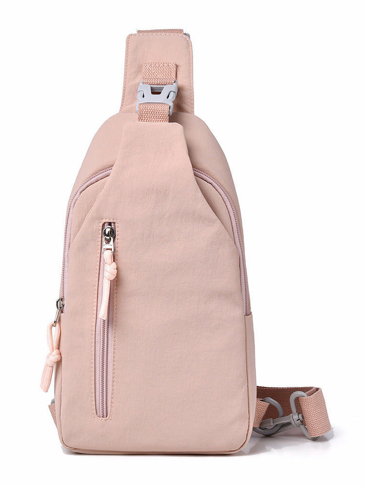 Pink sling bag with a strap on a white background