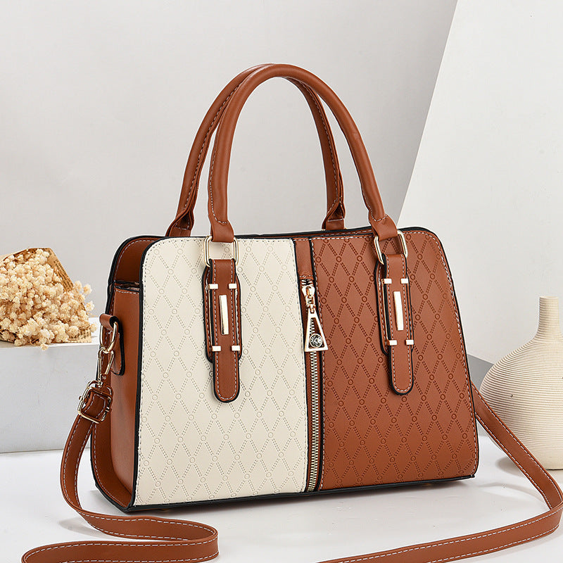 Brown and beige handbag with a strap on a light background