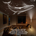 Room with a starry night light projection of a whale on the ceiling