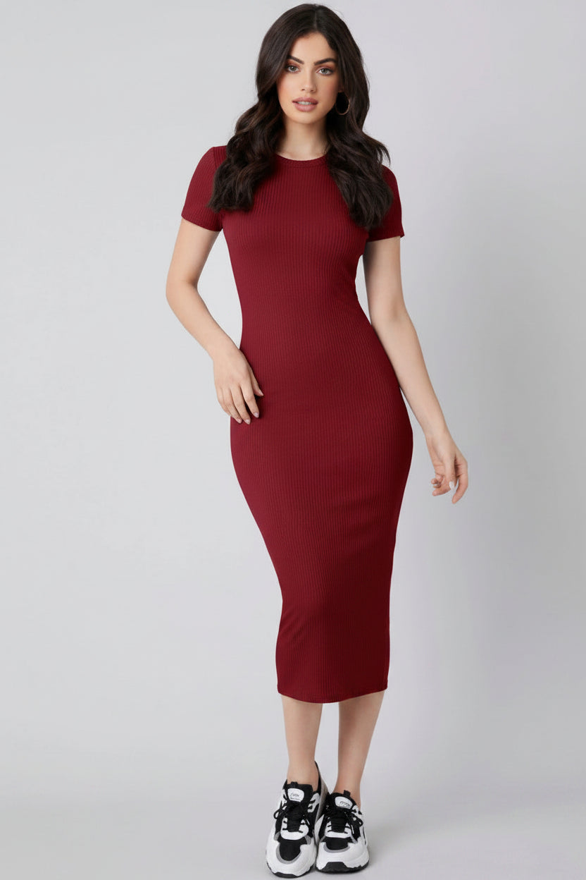 Woman wearing a burgundy dress on a gray background